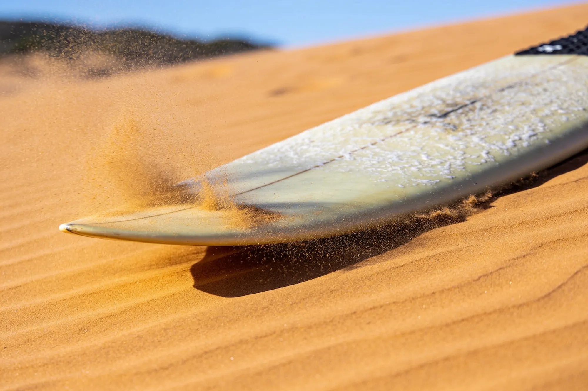Photo: A waxed board on the sand
