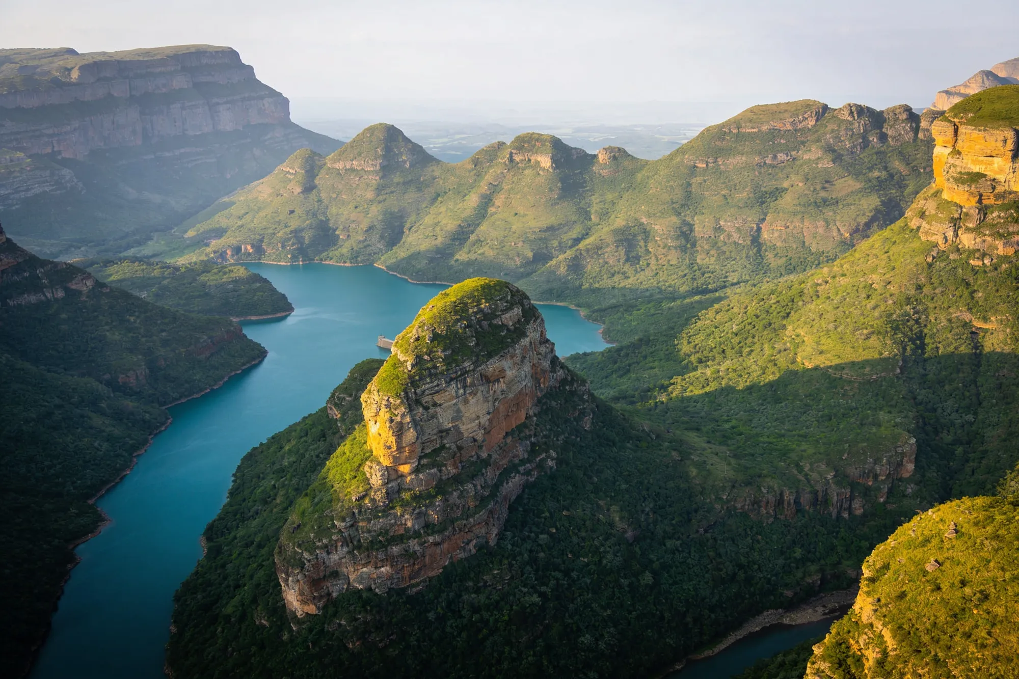 The Three Rondavels rising above the Blyde River Canyon and dam
