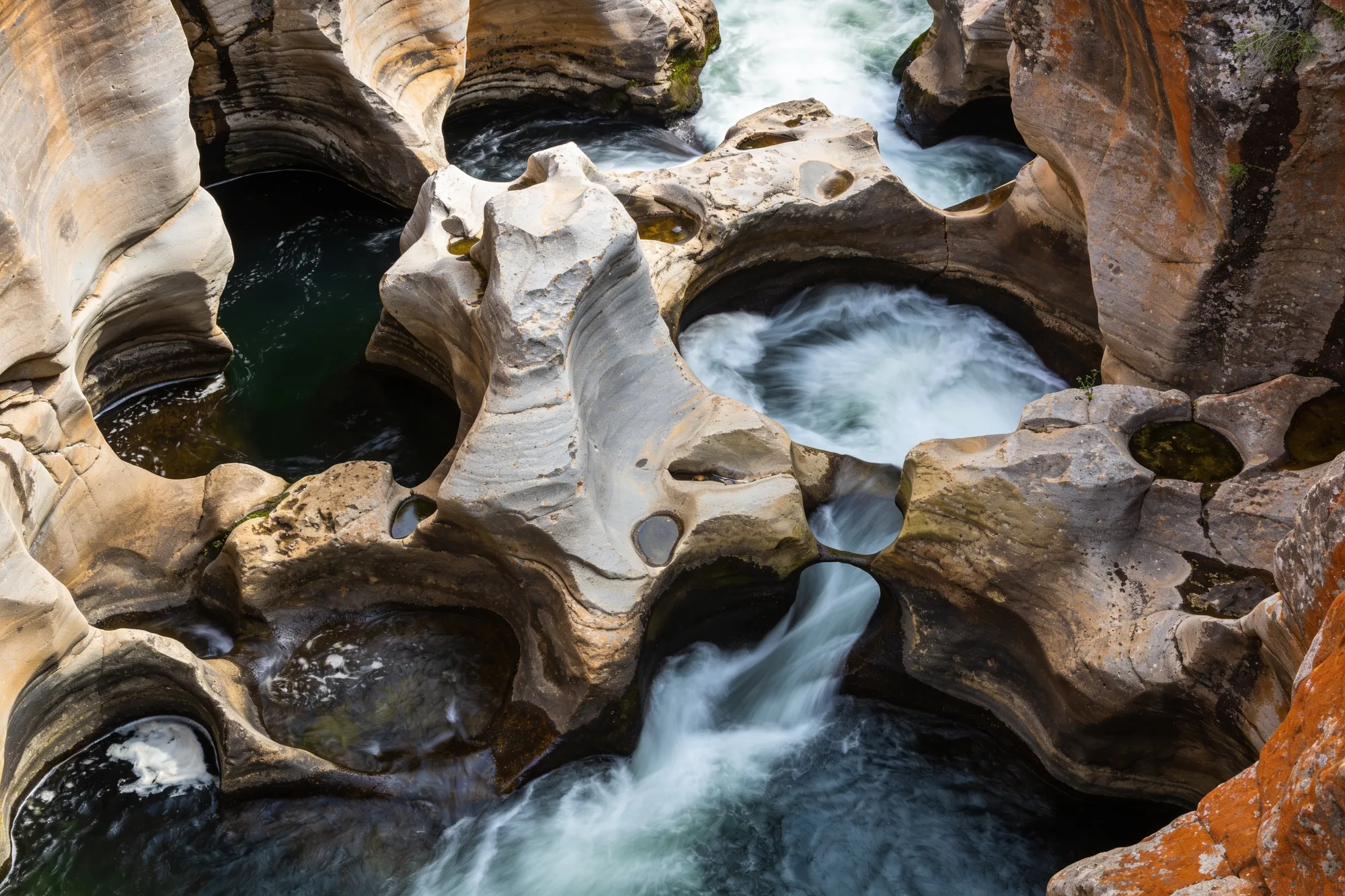 Photo — Water swirling through the rock