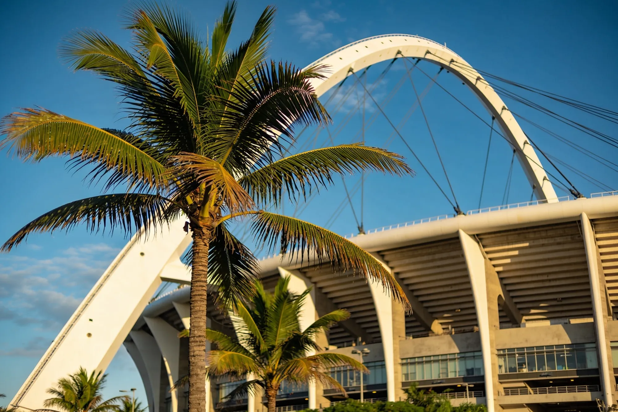 The great white arch of Moses Mabhida Stadium against the Durban sky