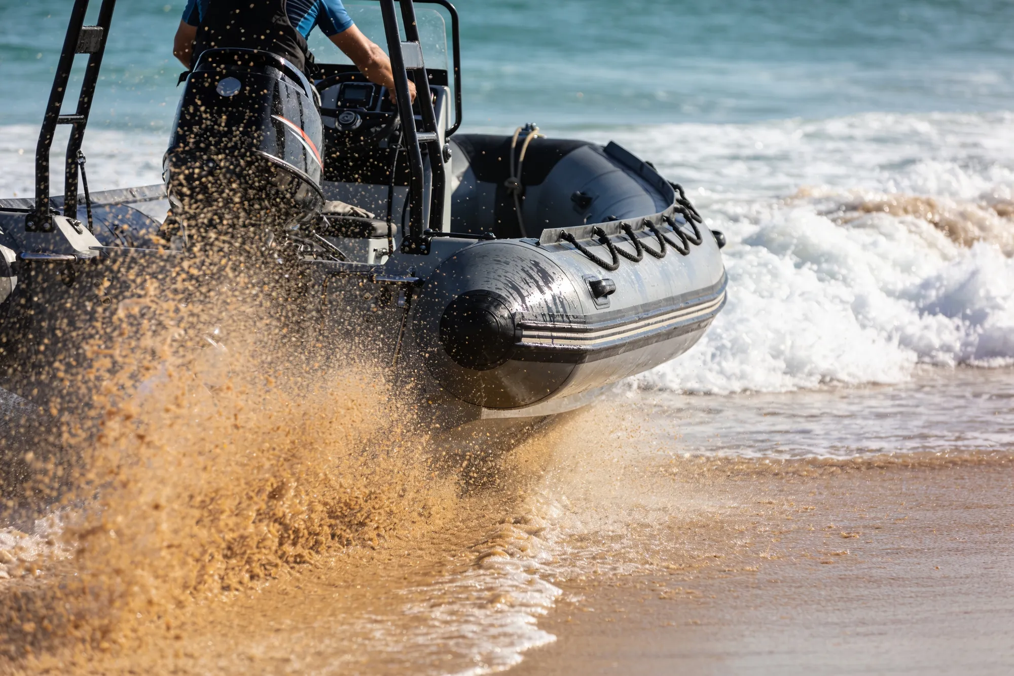 Photo — A dive boat launching through the surf