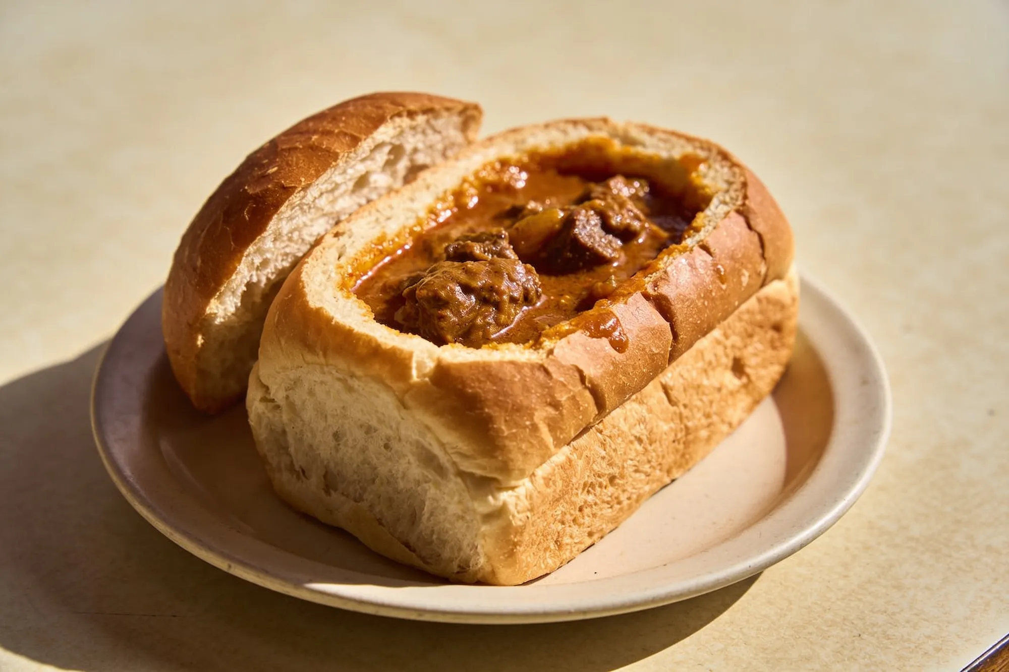Photo — A curry bunny chow